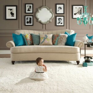 Cute baby sitting on carpet floor | Lynch Carpet & Flooring