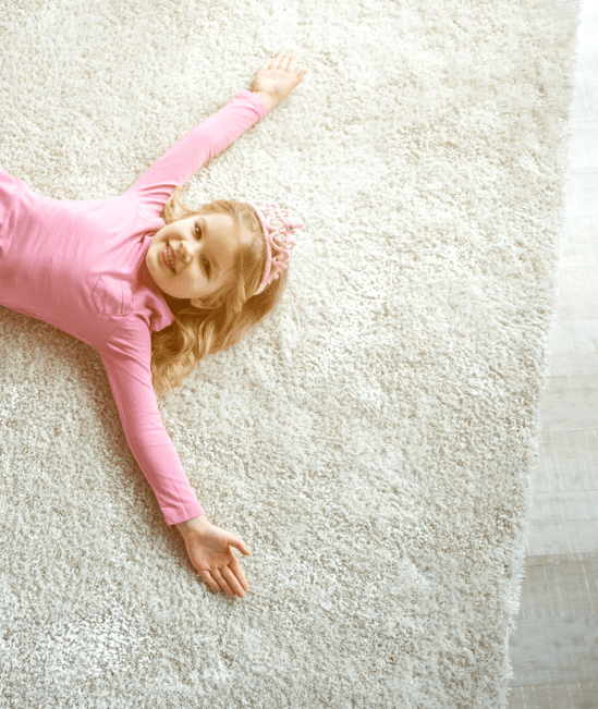 Cute girl laying on rug | Lynch Carpet & Flooring